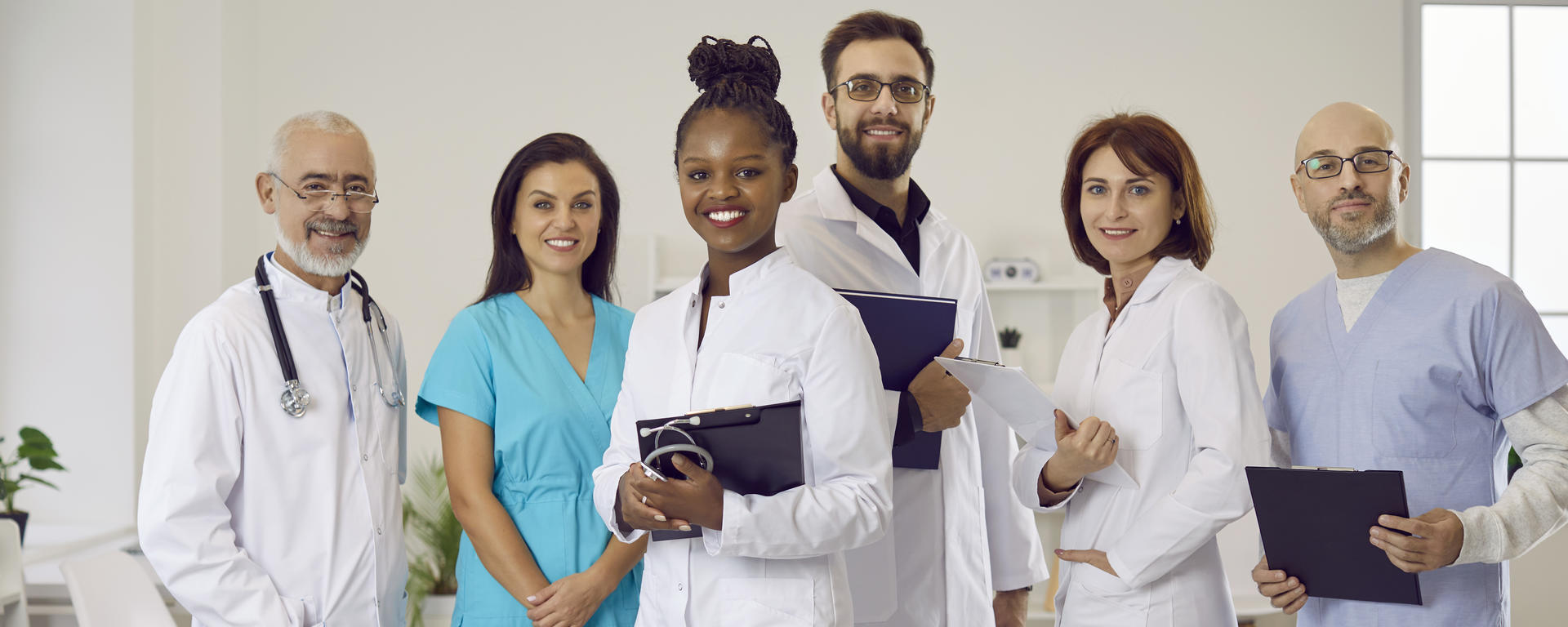 Team of diverse hospital staff posing for photo.