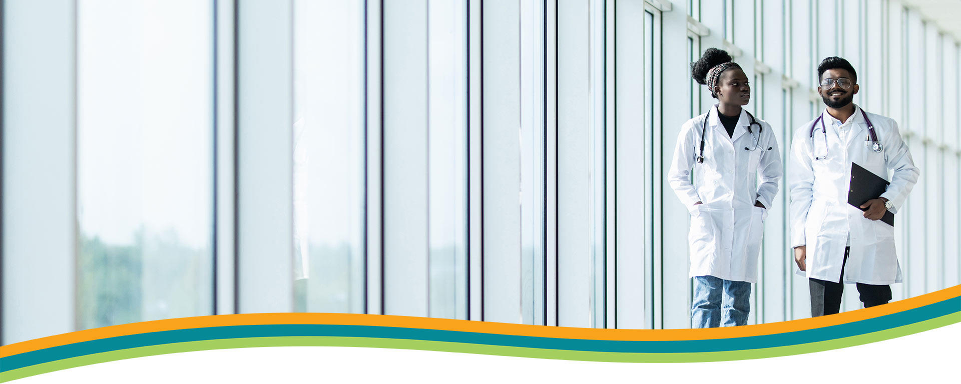 Two Doctors walking in a hallway - Physican Wellness