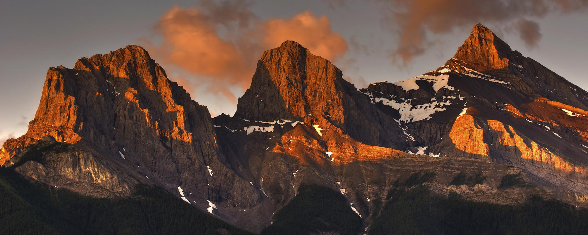 The Three Sisters mountains in Canmore Alberta Canada's Rocky Mountains as Sunrise