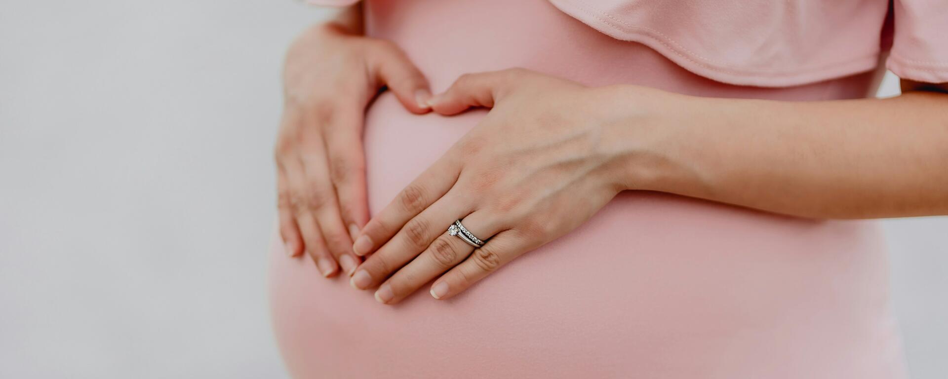 mother holding her baby bump