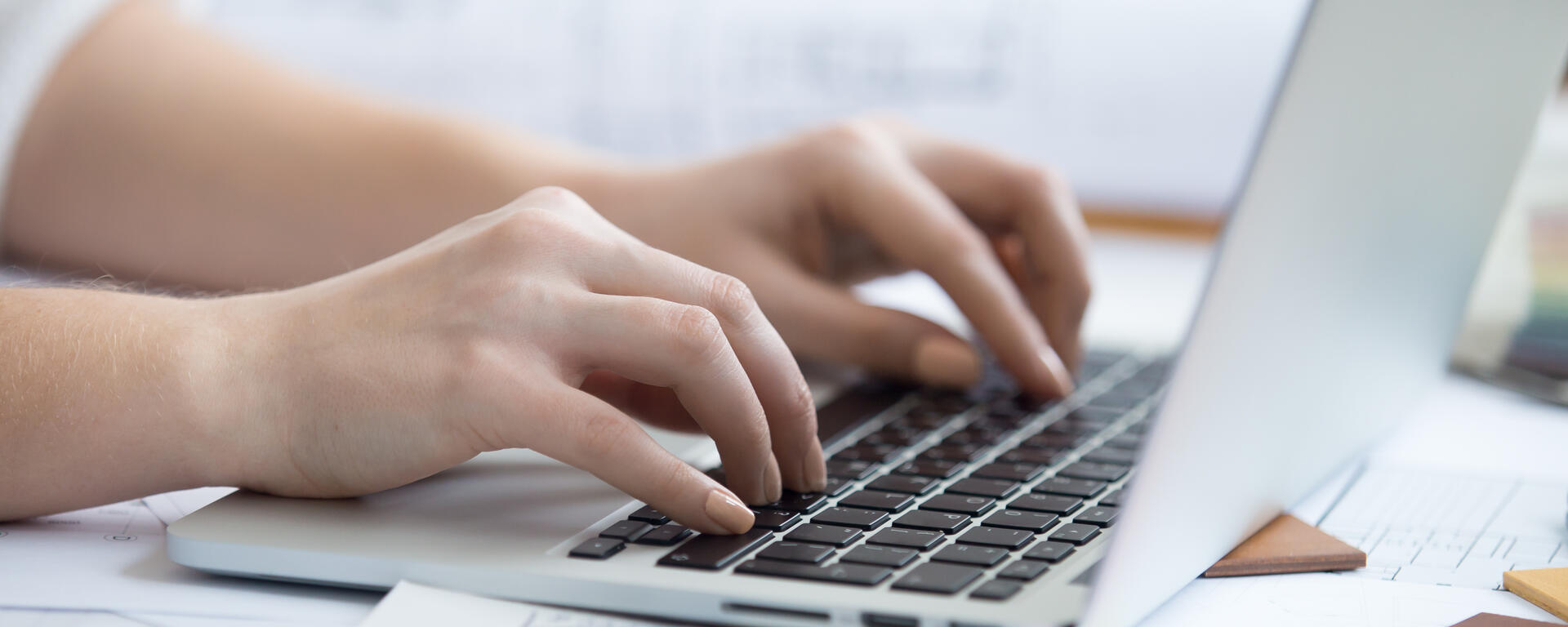 image of a person typing on a computer