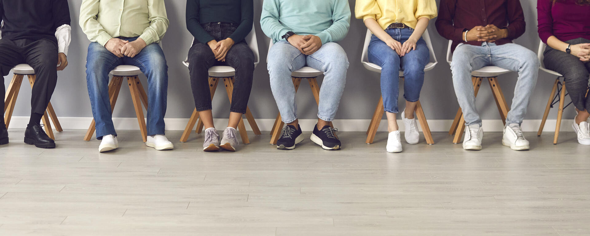 photo of people sitting in a chair in a row