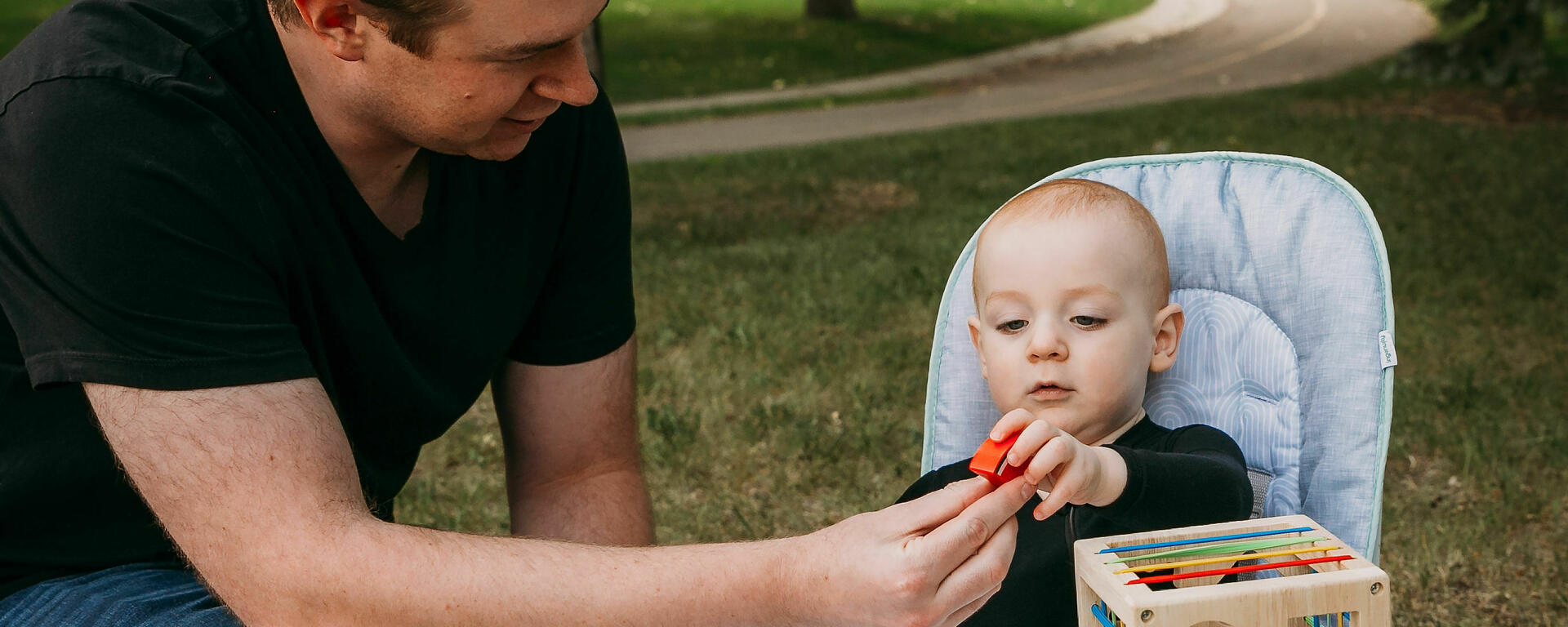 Dad passing toy to child