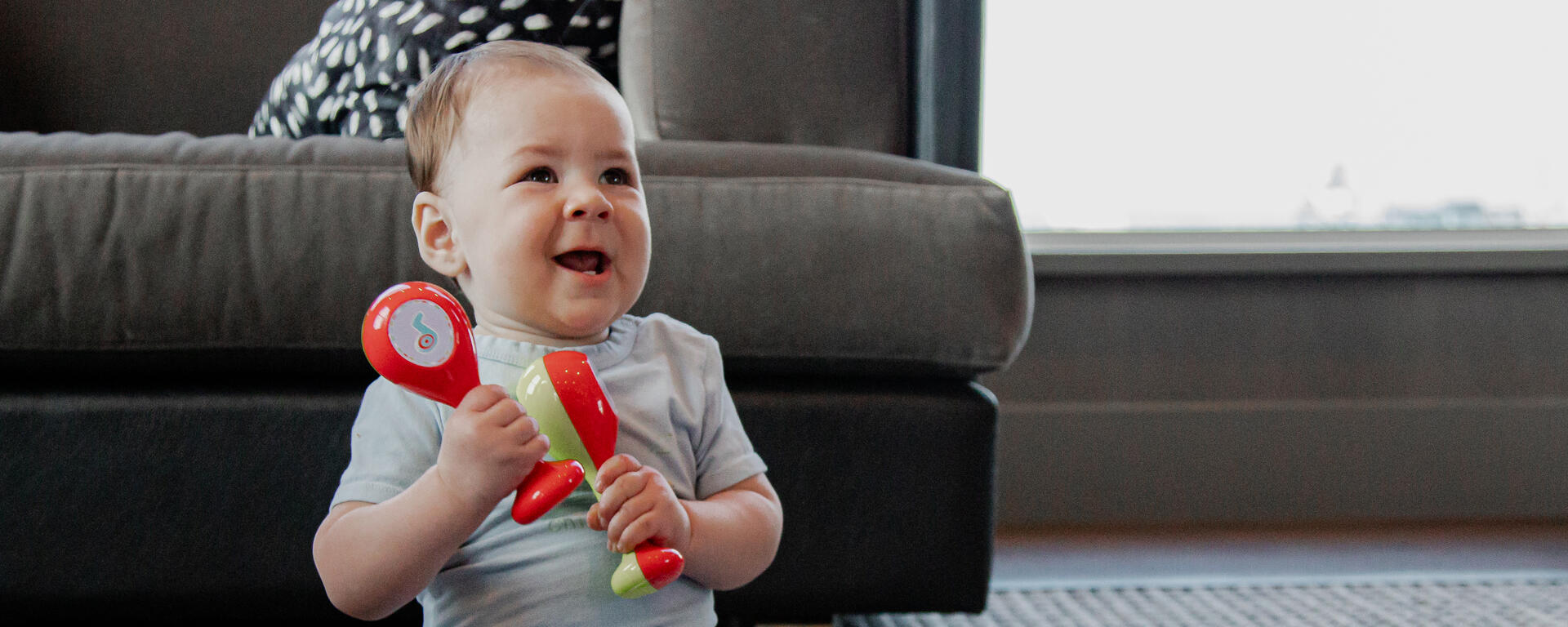 child shaking two rattles