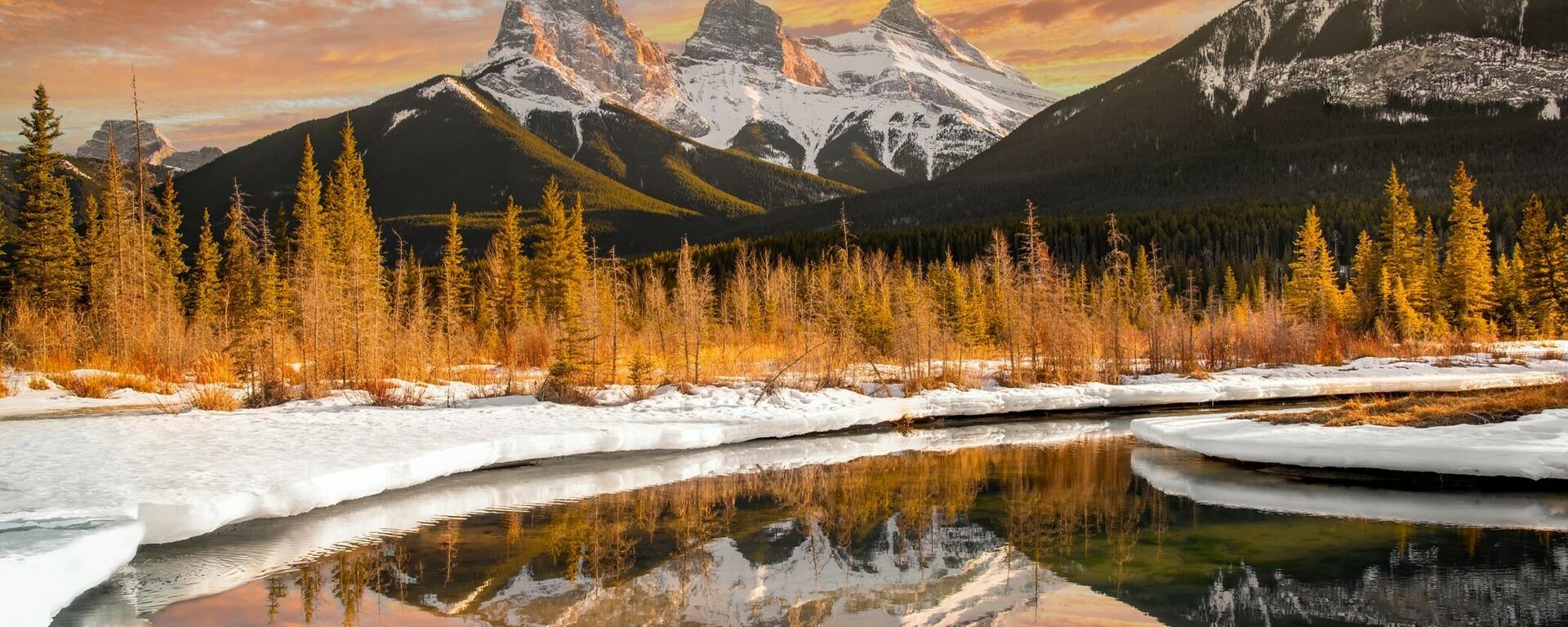 Evening sunset and reflection of three sisters, near Canmore, Alberta, Canada
