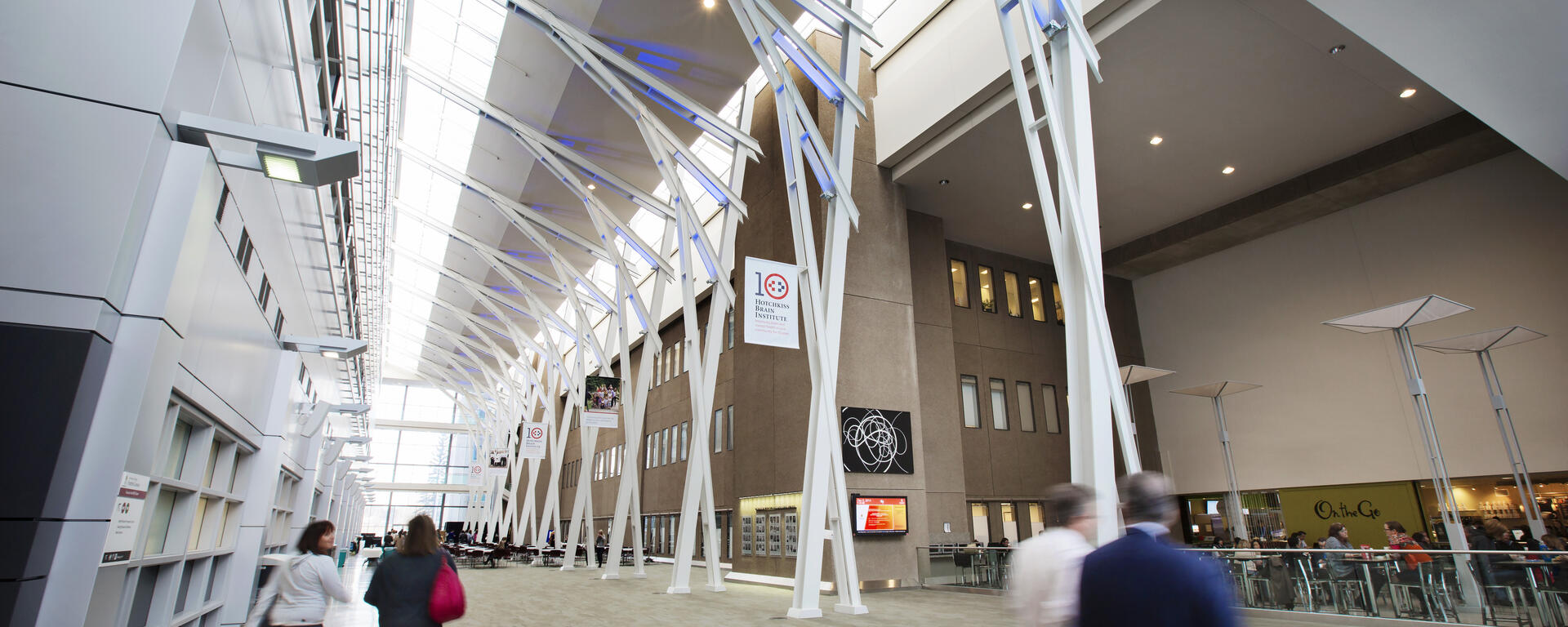 Photo of HRIC atrium at Foothills Campus. There are some figures walking in the space.