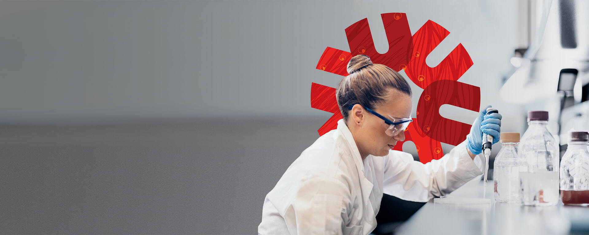 Researcher in a lab, measuring chemicals with a UCalgary red spark graphic behind them.