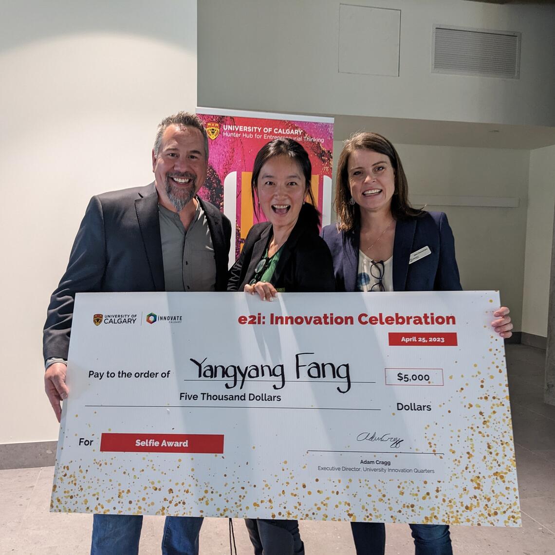  A photo of Dr. Yangyang Fang with Jeff Ryzner and Jane Desrochers. Yangyang is holding a cheque for $5,000 CAD
