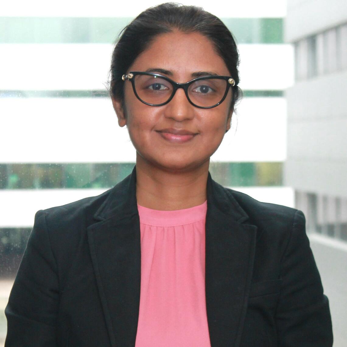 Dr. Afreefa Alladin, PhD Candidate, smiling in a professional headshot with a blurred background