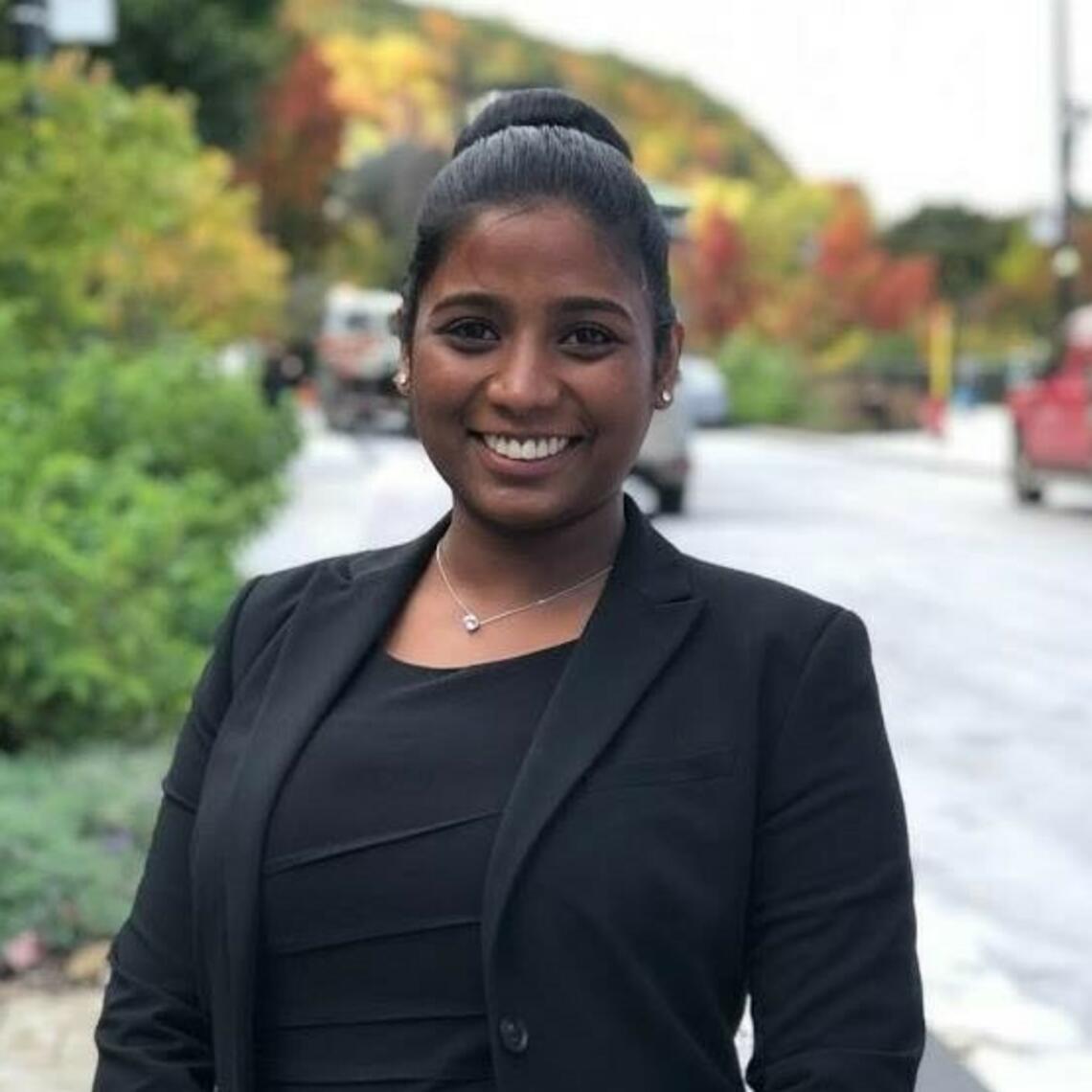 Himasara Pathiraja, PhD Candidate, smiling in a professional headshot with a blurred outdoor background