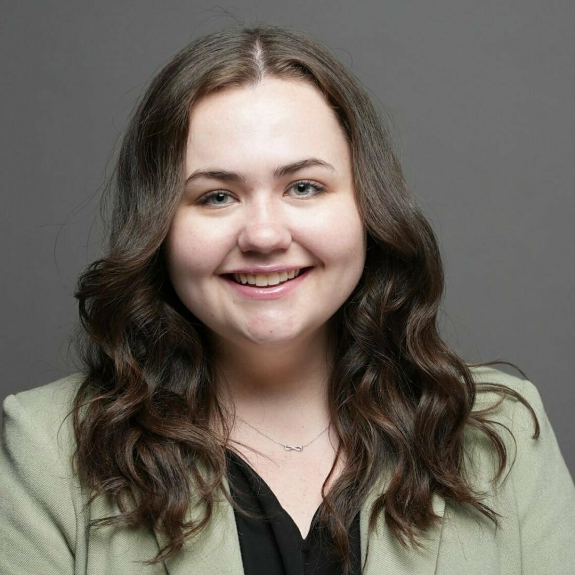 Megan Patton, PhD Candidate, smiling in a professional headshot with a neutral background