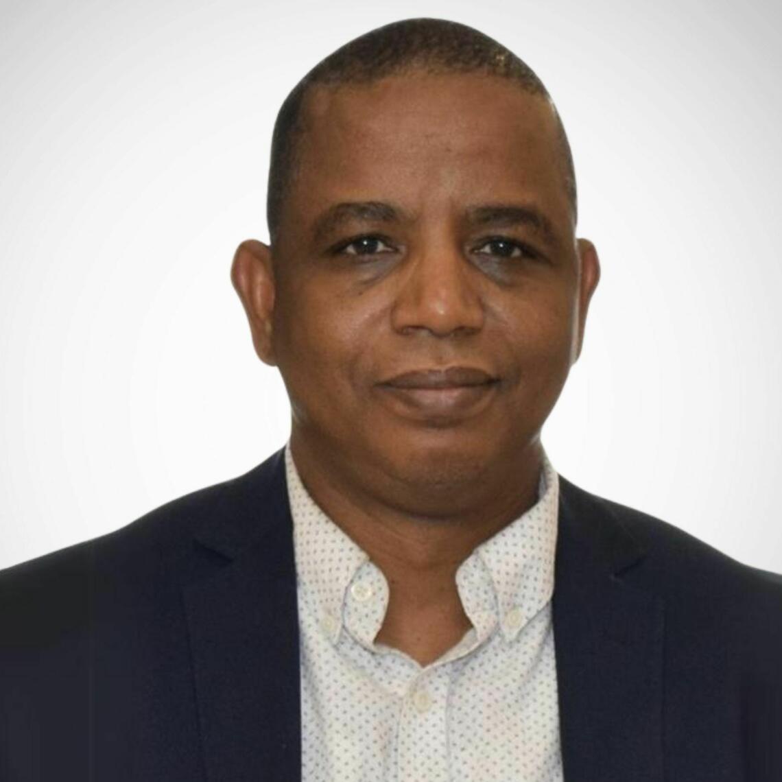 Dr. Aminu Bello, Professor of Medicine and Nephrologist at the University of Alberta, in a professional headshot with a neutral background