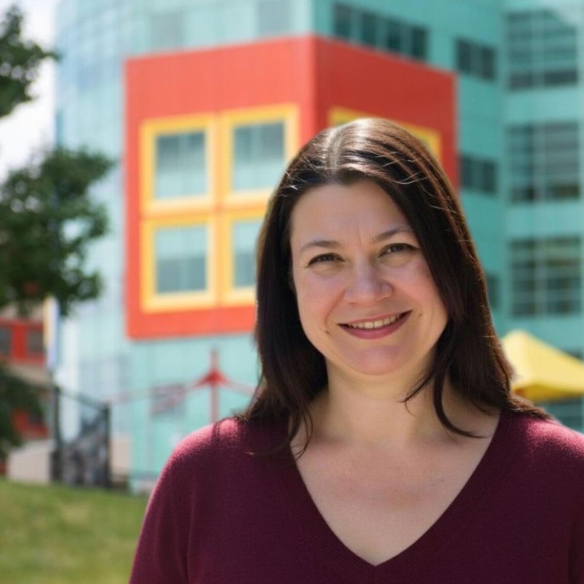 smiling woman with medium length brown hair