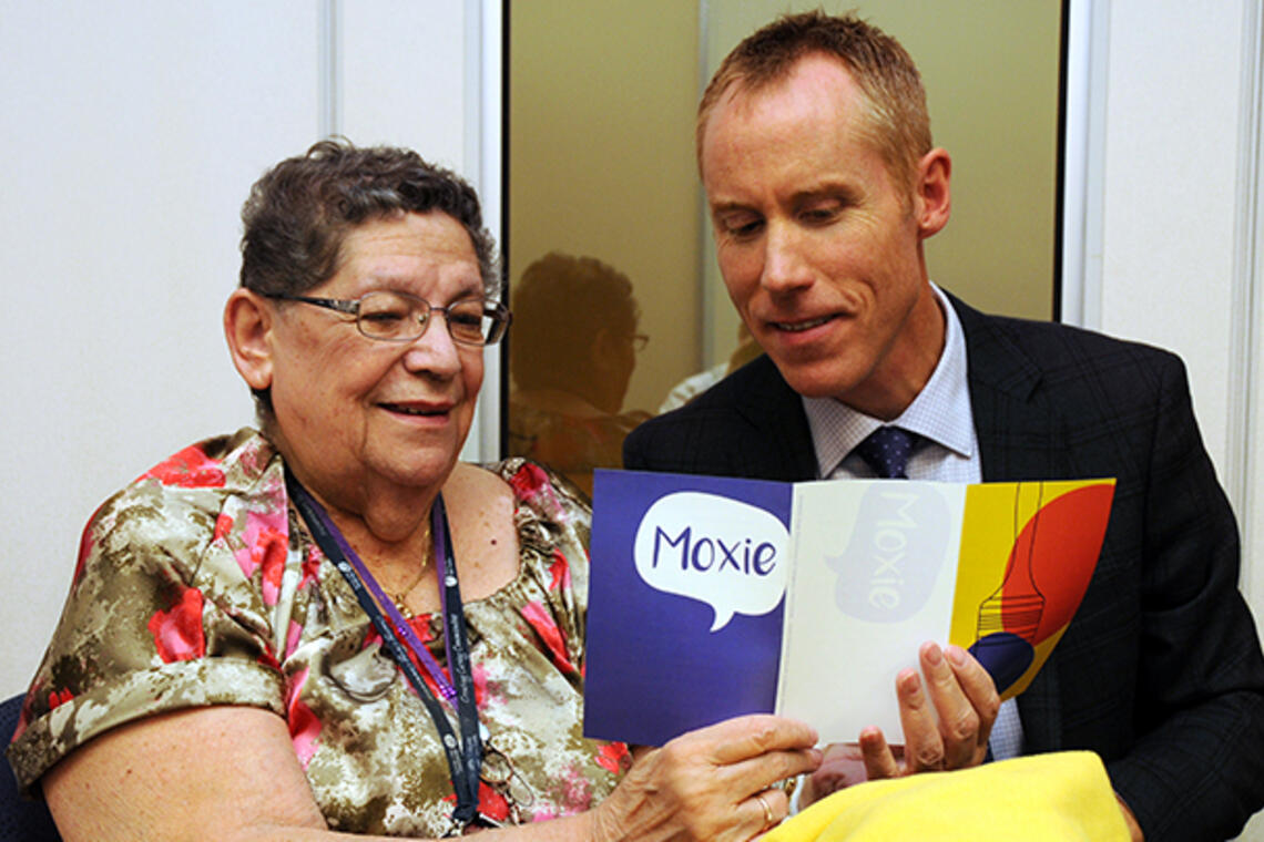 Photo of Dr. Braden Manns showing a patient the Moxie education material