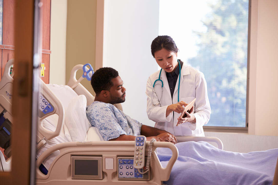 patient and doctor reviewing charts and results on an Ipad