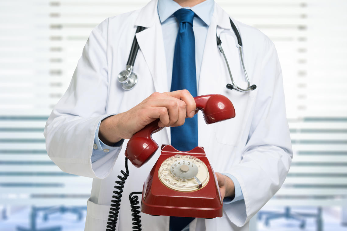 A doctor with a telephone in his hand