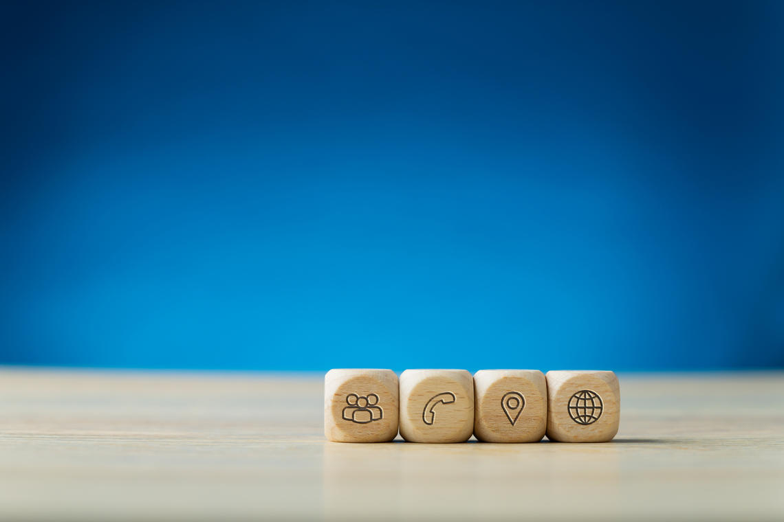 Wooden cubes with contact icons on them