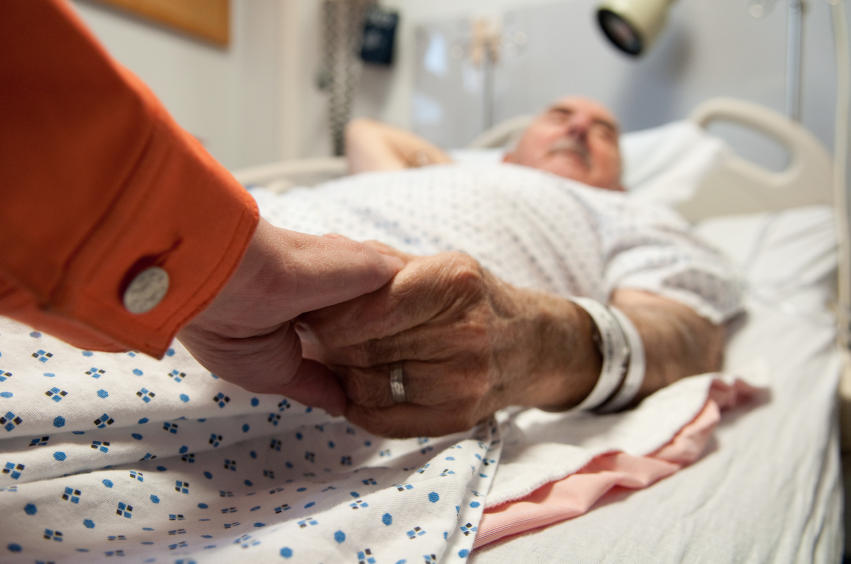Family member holding patient's hand