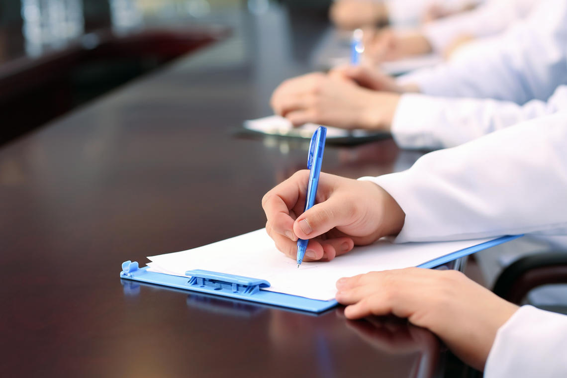 Medical workers writing in conference room