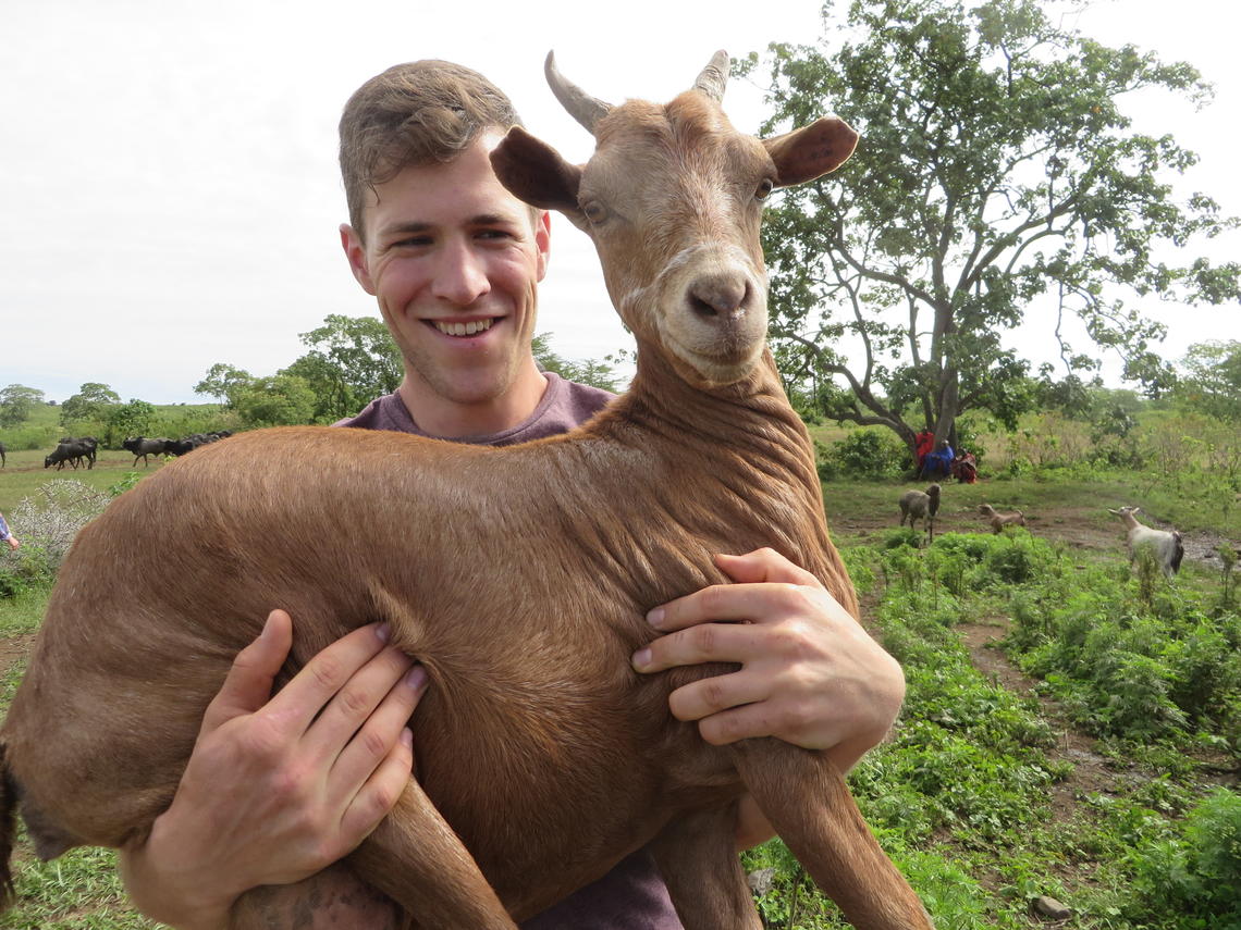 man holding a goat