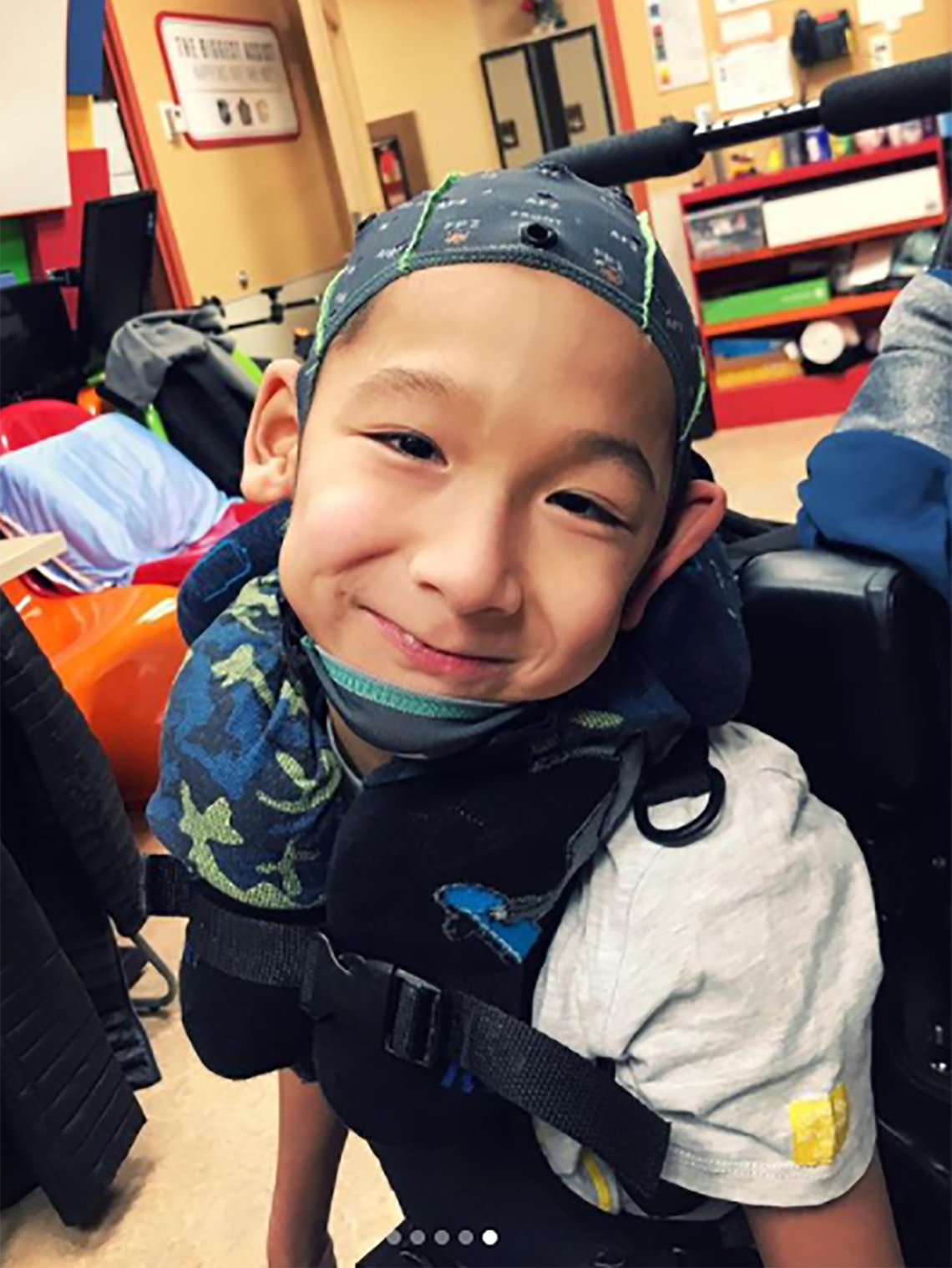 A boy with cerebral palsy wearing an EEG headcap