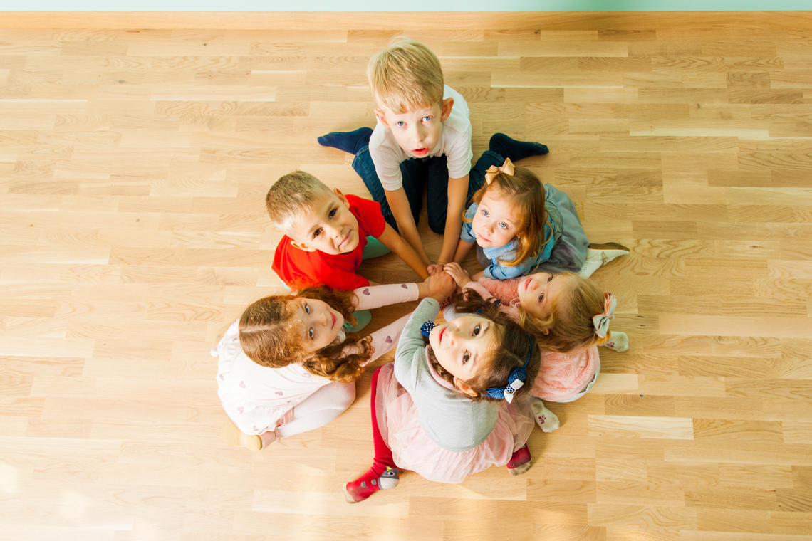 Children holding hands looking up