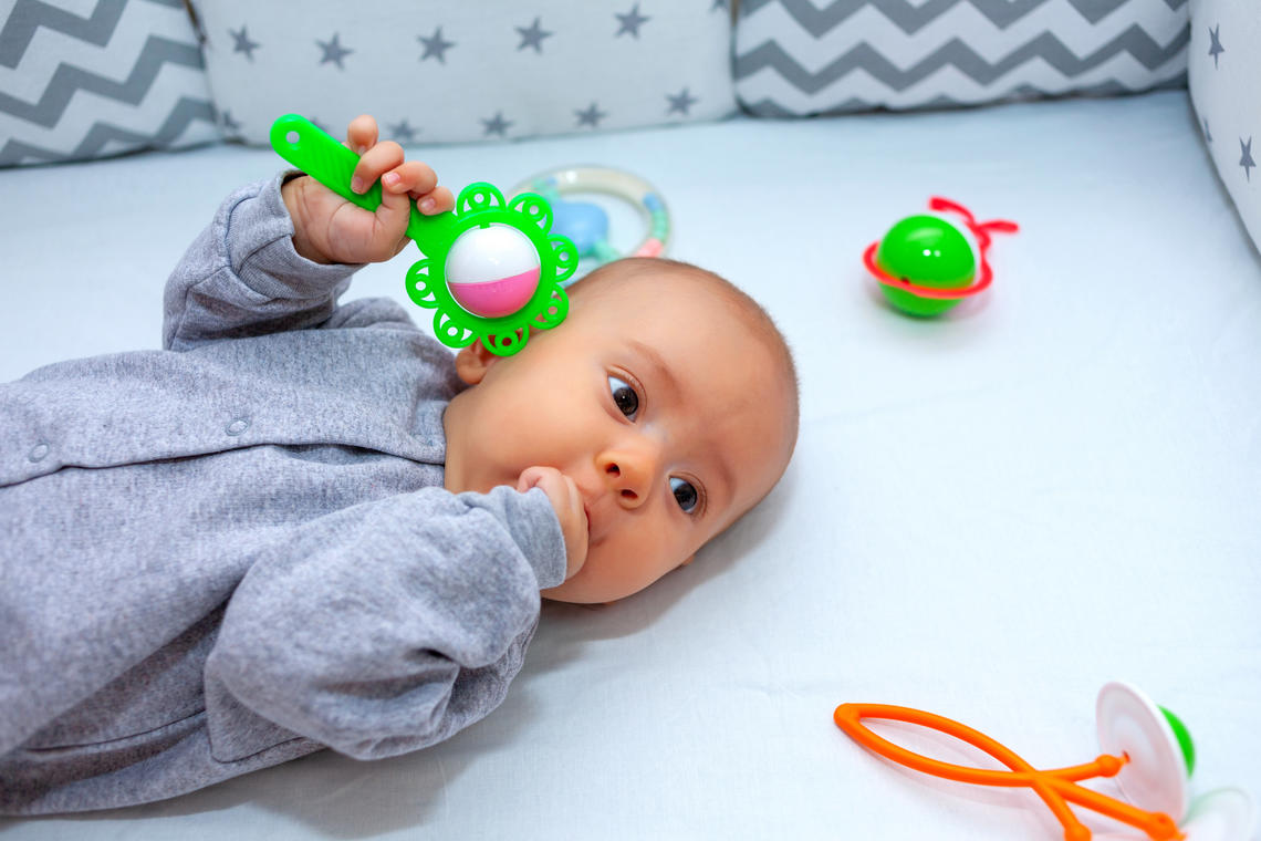 Baby with rattle