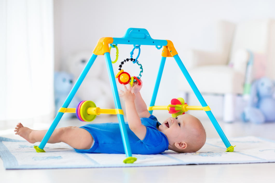 baby reaching for toys