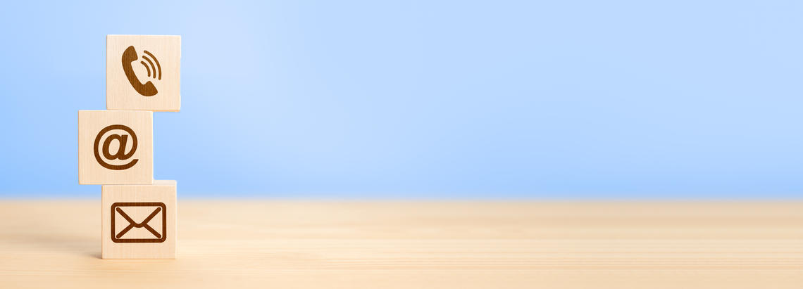 contact icons on stacked wooden blocks