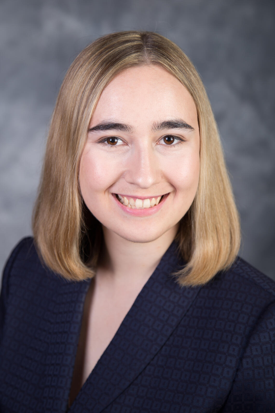 photograph of Kate Bourne - blond hair to neck, Caucasian, blue dress shirt