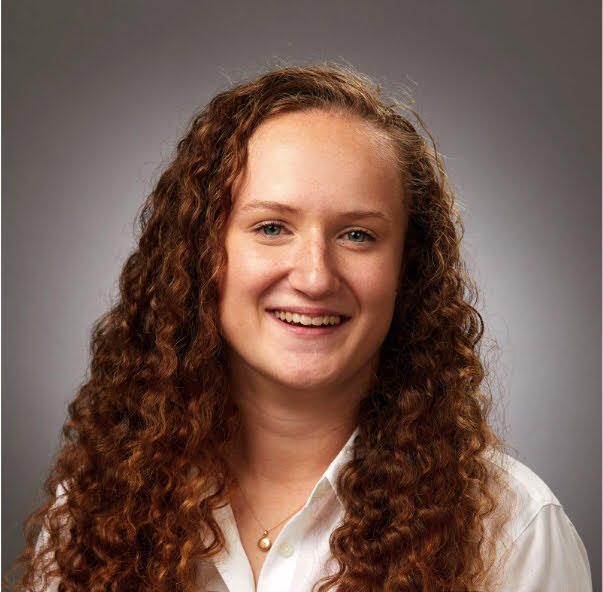 photograph of elizabeth fletcher with red/brown curly hair past the shoulders, caucasian