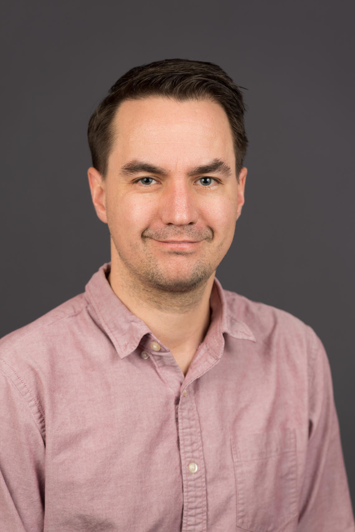 photograph of Dr. Jared Fletcher - caucasian, short brown hair, blue collared  button up shirt