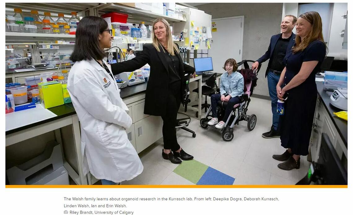 The Walsh family learns about organoid research in the Kurrasch lab. From left: Deepika Dogra, Deborah Kurrasch, Linden Walsh, Ian and Erin Walsh.