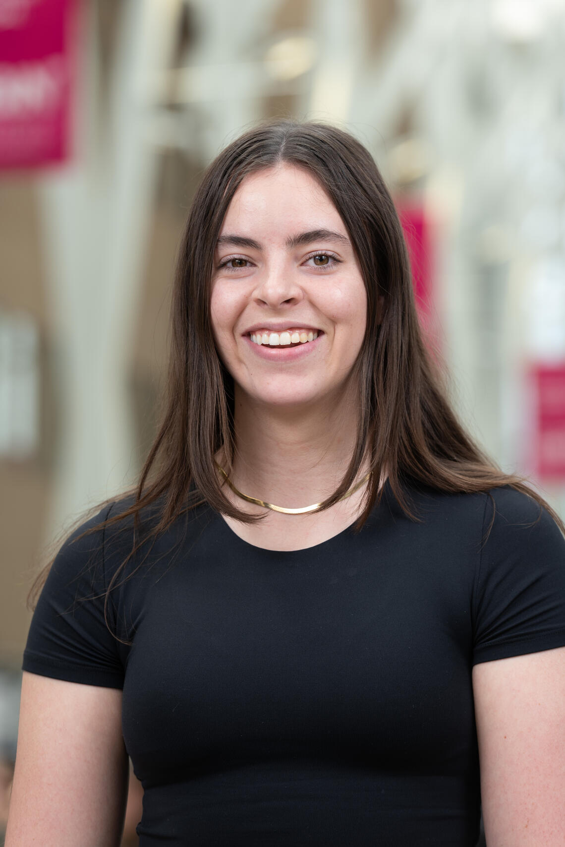Caucasian female with brown shoulder length hair and black shirt