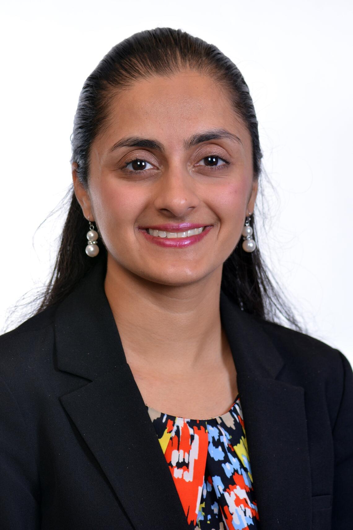 photograph of female researcher of Indian descent in black blazer and multicoloured blouse