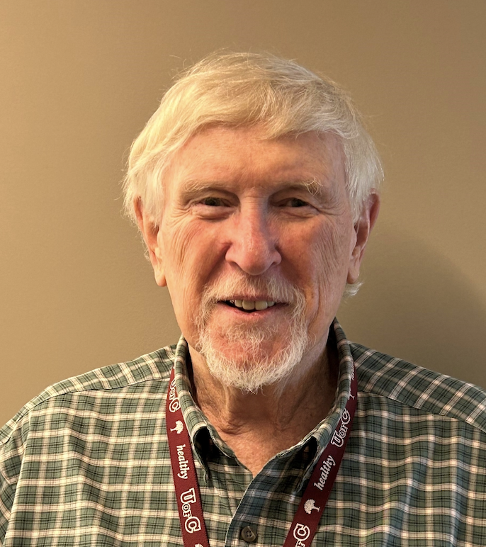 Photo of older Caucasian male with white beard and green checkered collared shirt