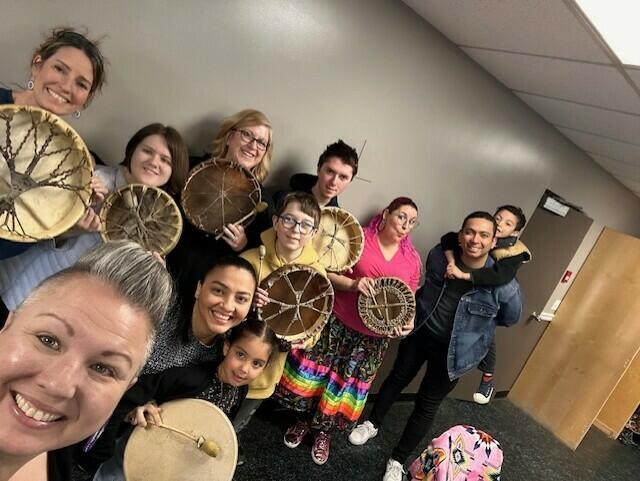many smiling people holding drums
