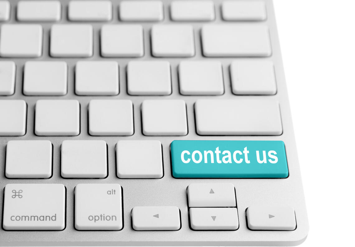 The right half of a white keyboard, with the shift key replaced with a blue contact us key