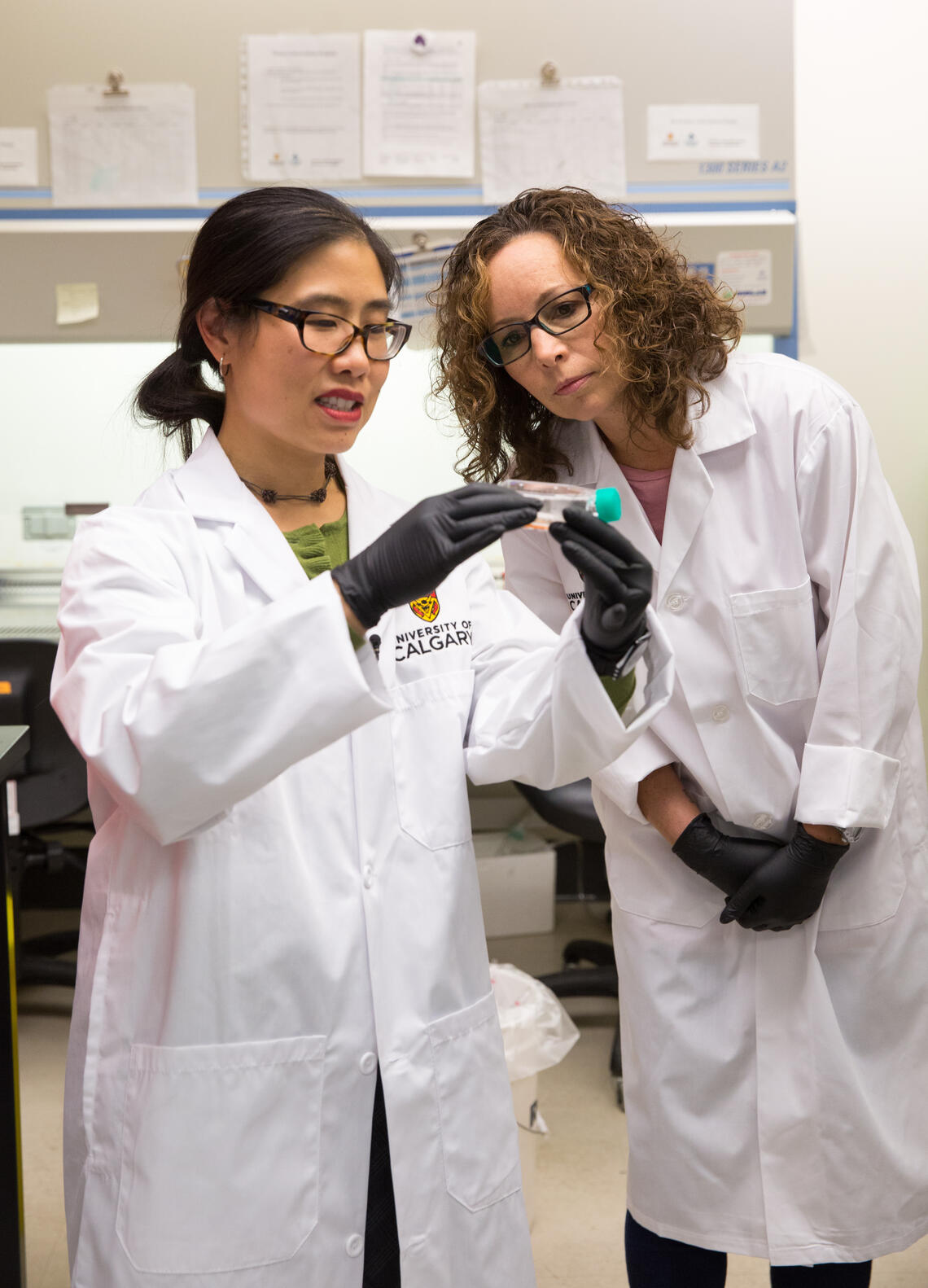2 women looking at medical device in hand
