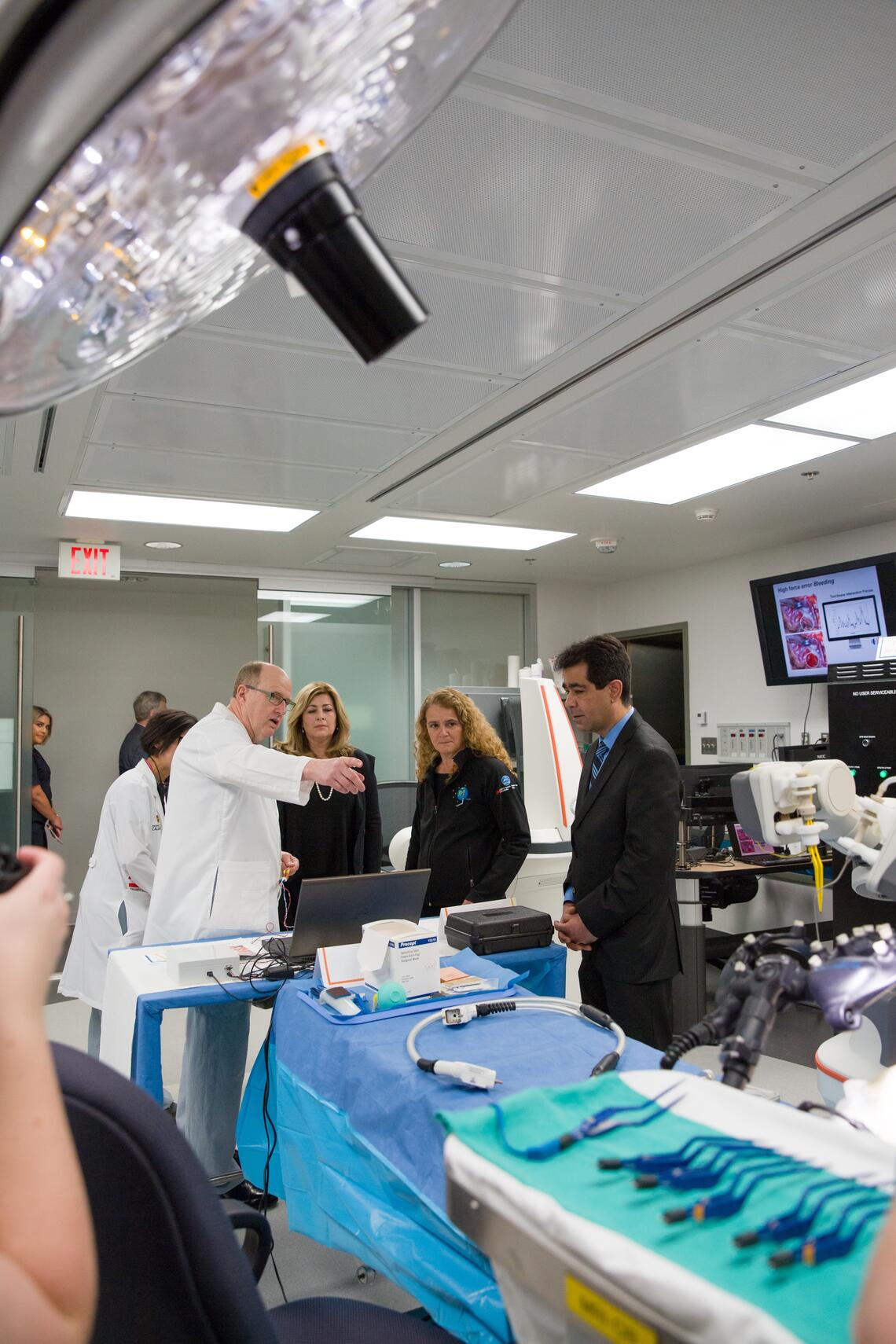 researchers gathered around a lab table discussing