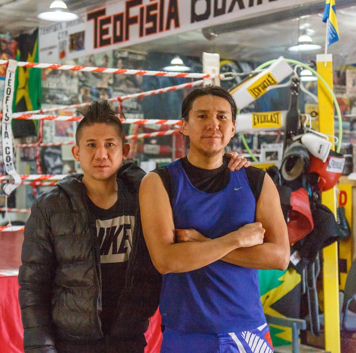 warrior fathers promo image with the two main individuals within the film standing in front of a boxing ring