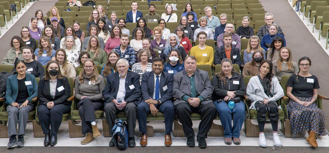 Group photo from Hope For Hypermobility Day 2024. Attendees are sitting in rows facing the camera.