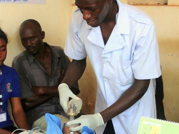 A nurse demonstrates how to resuscitate a baby using a SIM doll, Mbarika, Misungwi