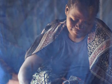 A mother cuddles her 10 hour old baby, Nyamayinza, Misungwi