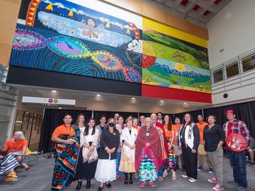 Group photo with the mural in the background