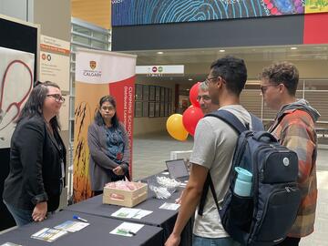 BeckyBradbury and Grace Perez attending to students at DLRI's 2024 Rural Health Week stall