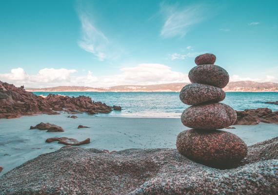 Photograph of stacked stones on the beach by Alejandro Piñero Amerio on Unsplash