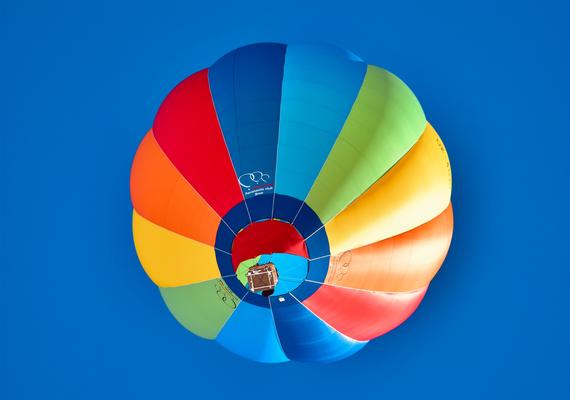 Colourful hot air balloon in blue sky. Photo by Daniel Hodgkins on Unsplash