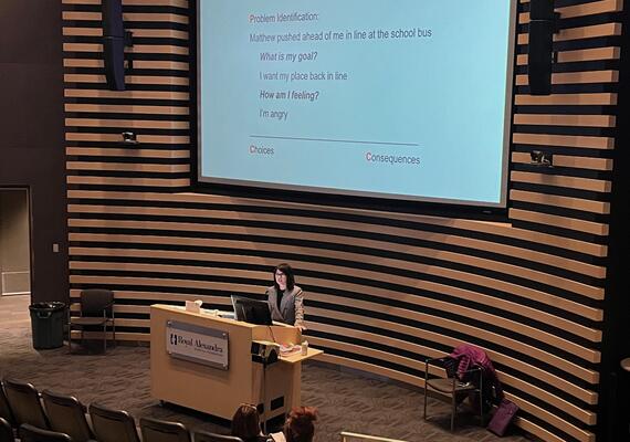 Tamara presenting to an audience in Edmonton