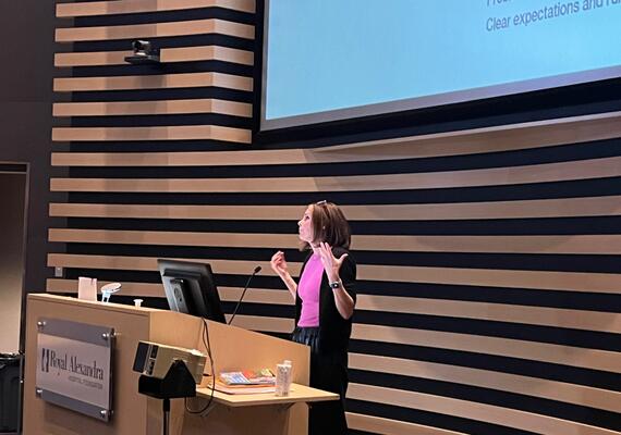 Cherl presenting to audience in Edmonton